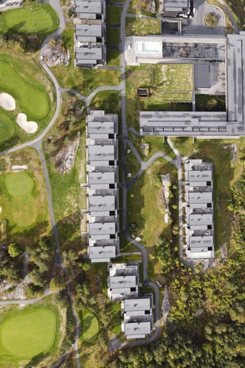 an aerial view of a building surrounded by trees